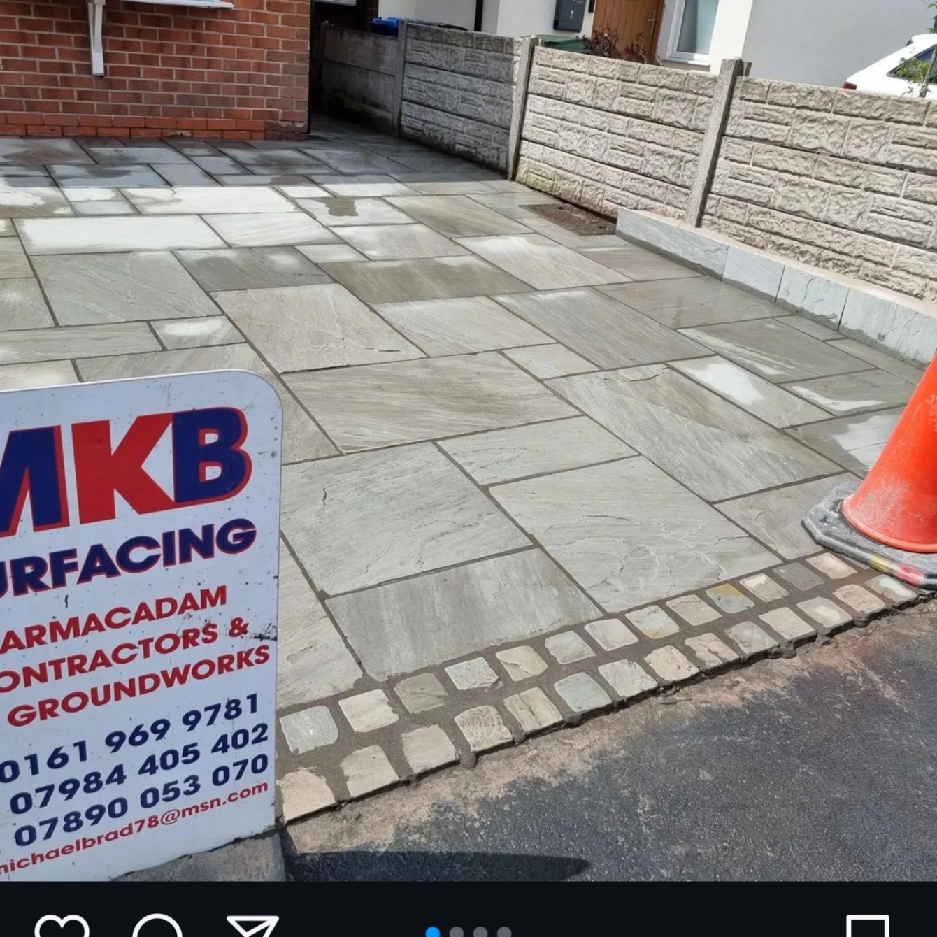 Natural stone paving with cobble border and MKB Surfacing contractor sign
