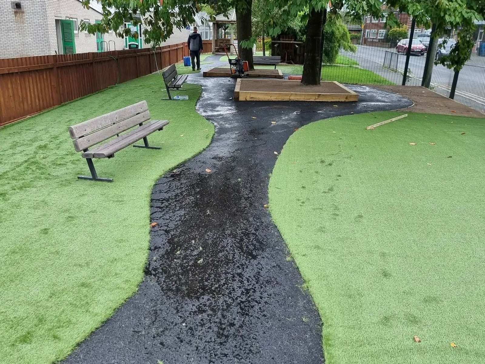 Tarmac path and artificial grass finishing in an outdoor communal space